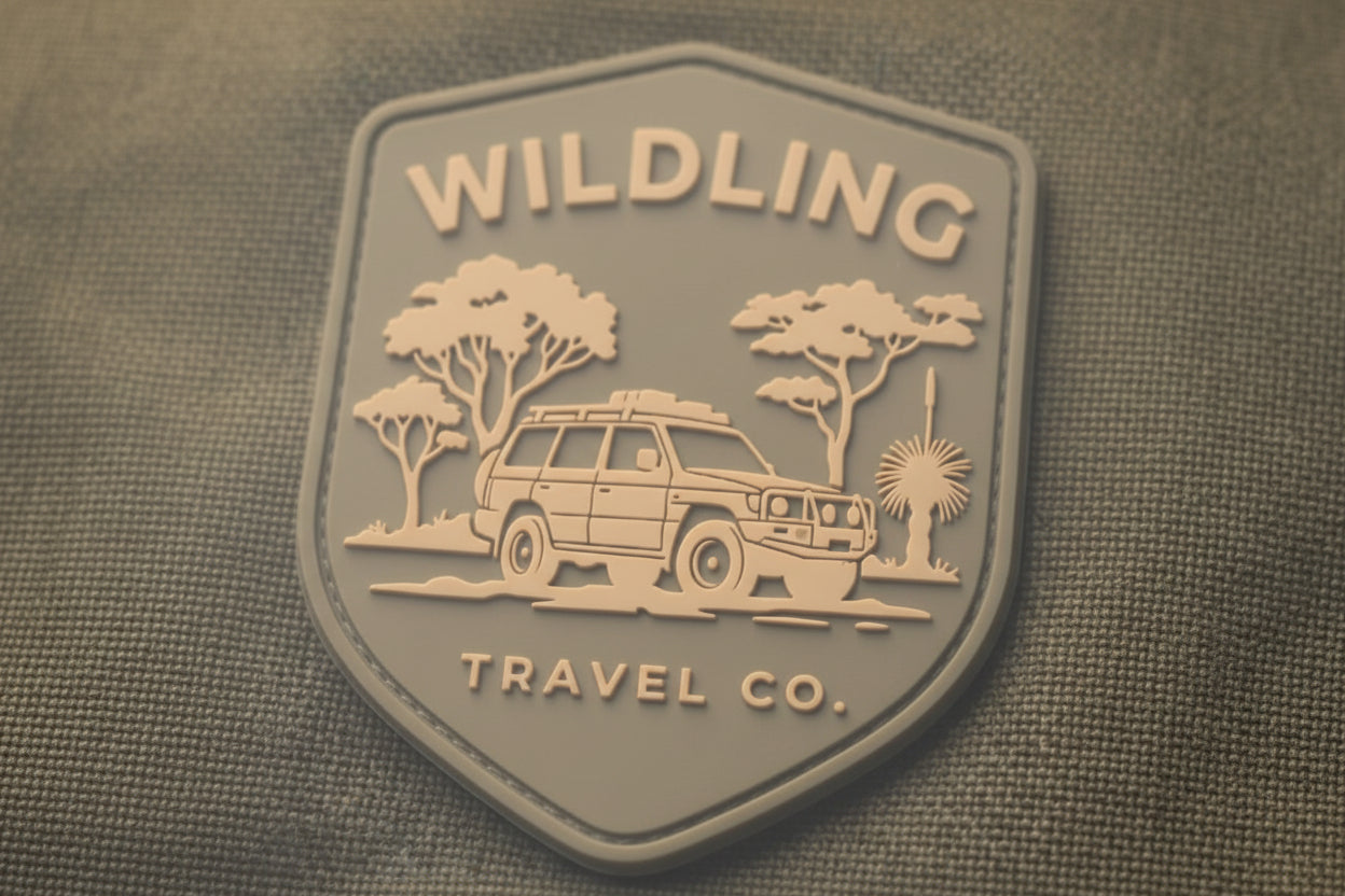 Wildling Travel Co. logo on a textured surface